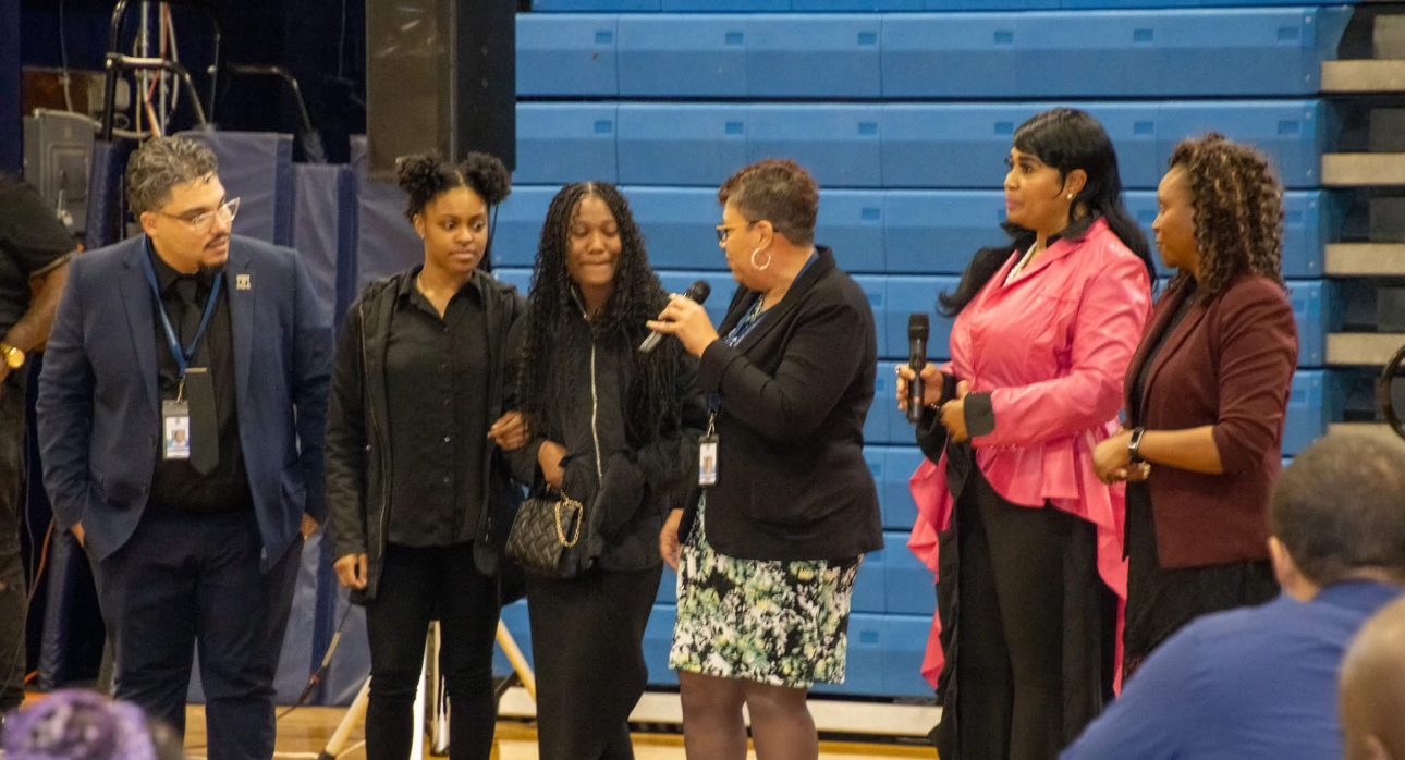 District and city leaders speak to two members of Manuel Moore' family